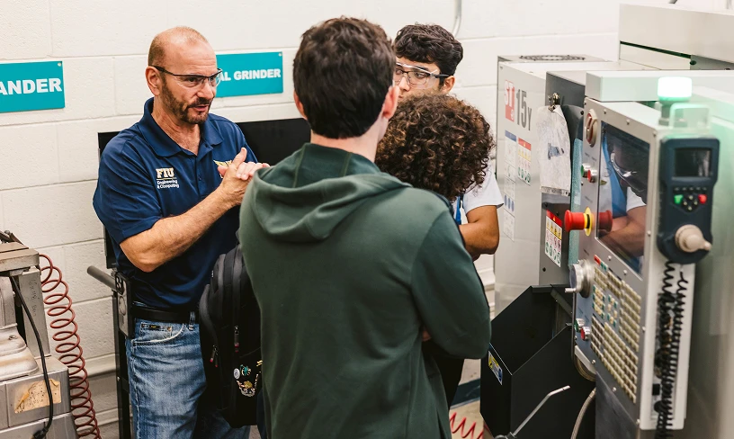 FIU professor works with students in a materials engineering lab
