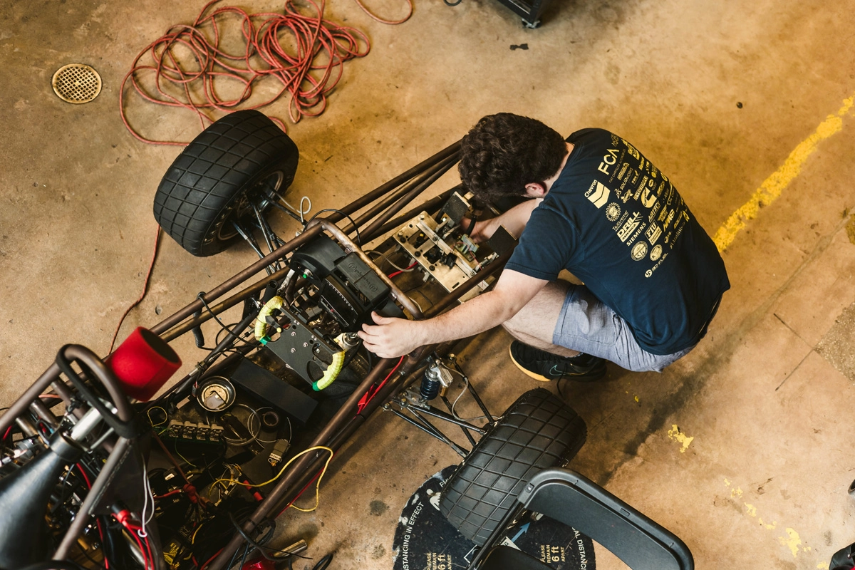 Student working on a vehicle