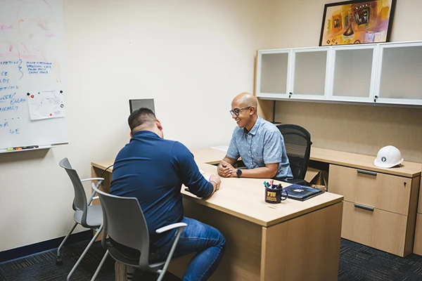 FIU CEC student speaking to faculty member
