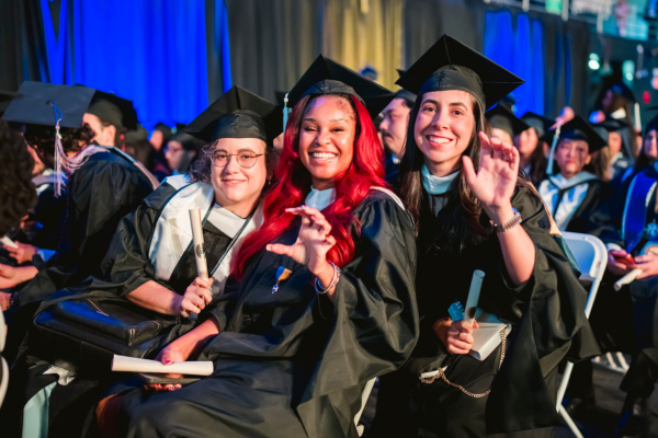 FIU alumni at graduation smiling