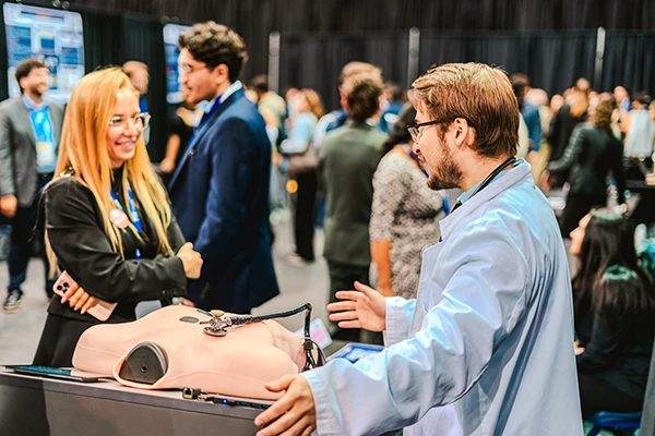 FIU CEC student at engineering showcase with medical manikin