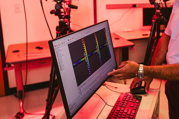 Researcher pointing at screen with optical data