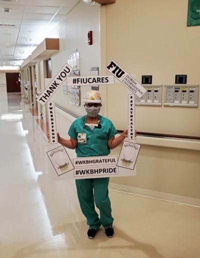 Nurse posing with FIU Border; Thanking FIU