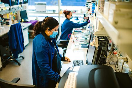 Woman working at a laboratory on a laptop